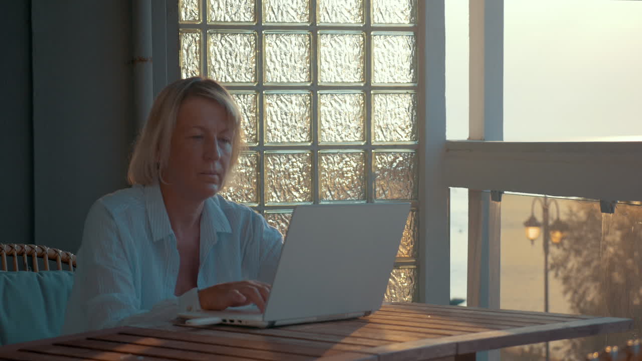 Woman using laptop and mobile internet device