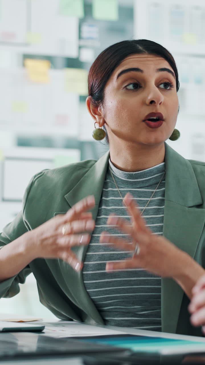Young Businesswoman Talking and Gesturing During an Office Meeting