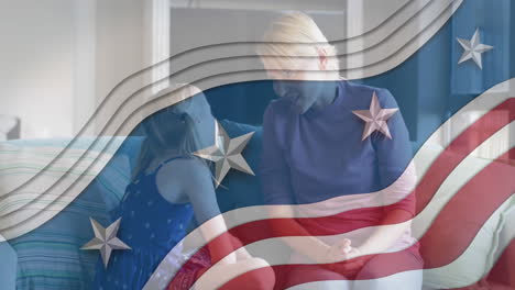 american flag design pattern against caucasian mother talking to her daughter at home