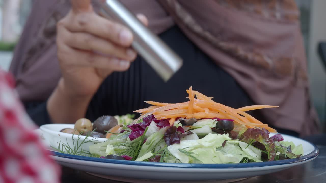 Woman eating salad at a restaurant