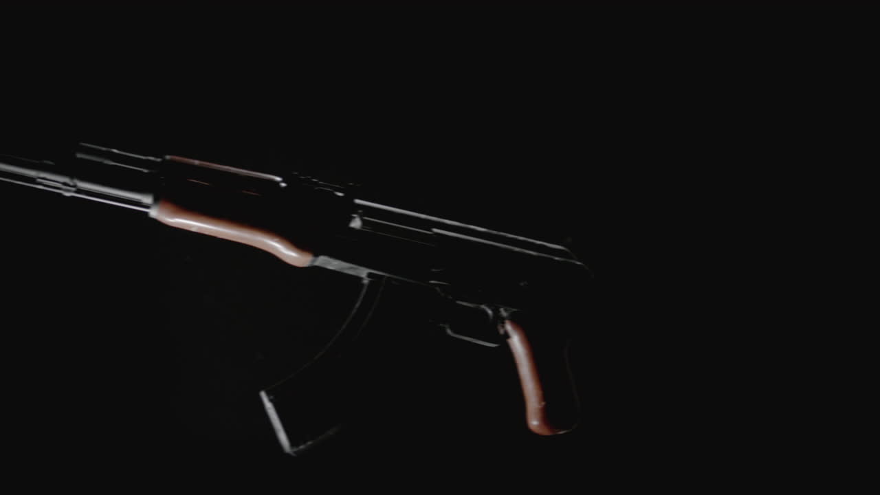 Machineguns on the dark background rotate in slowmotion