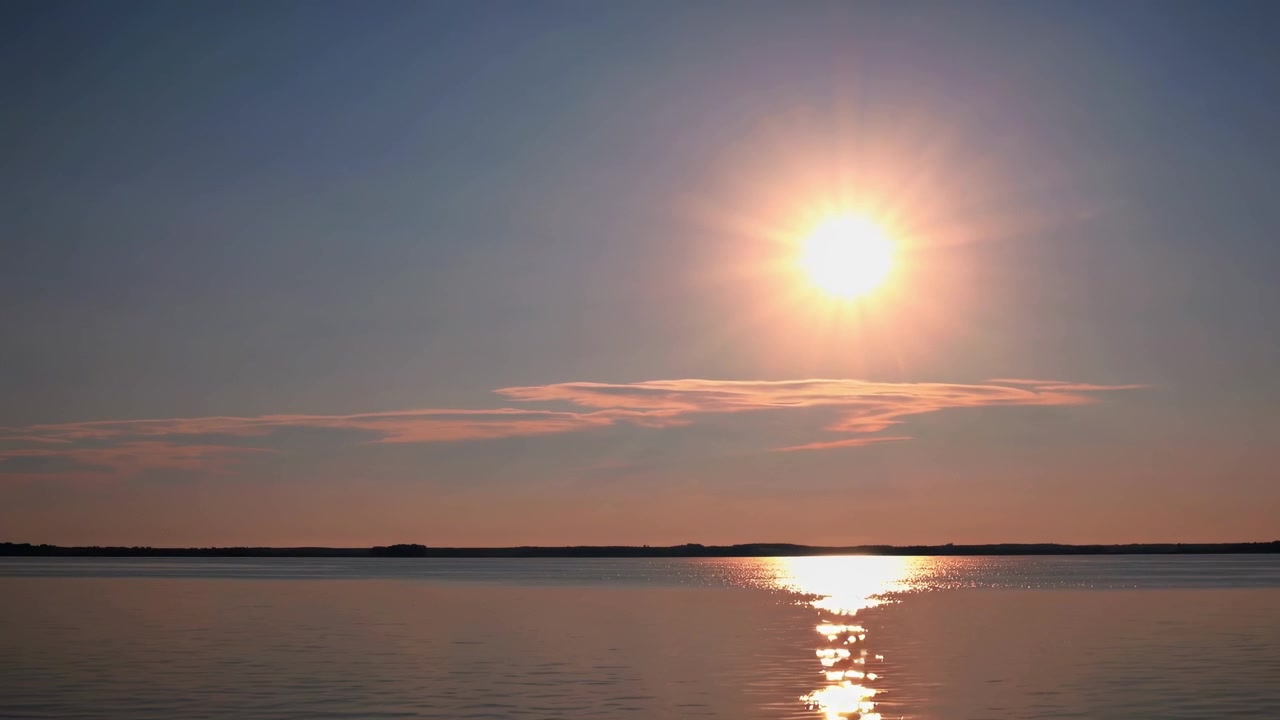 Bright Sun Shining Over Calm Lake at Sunset