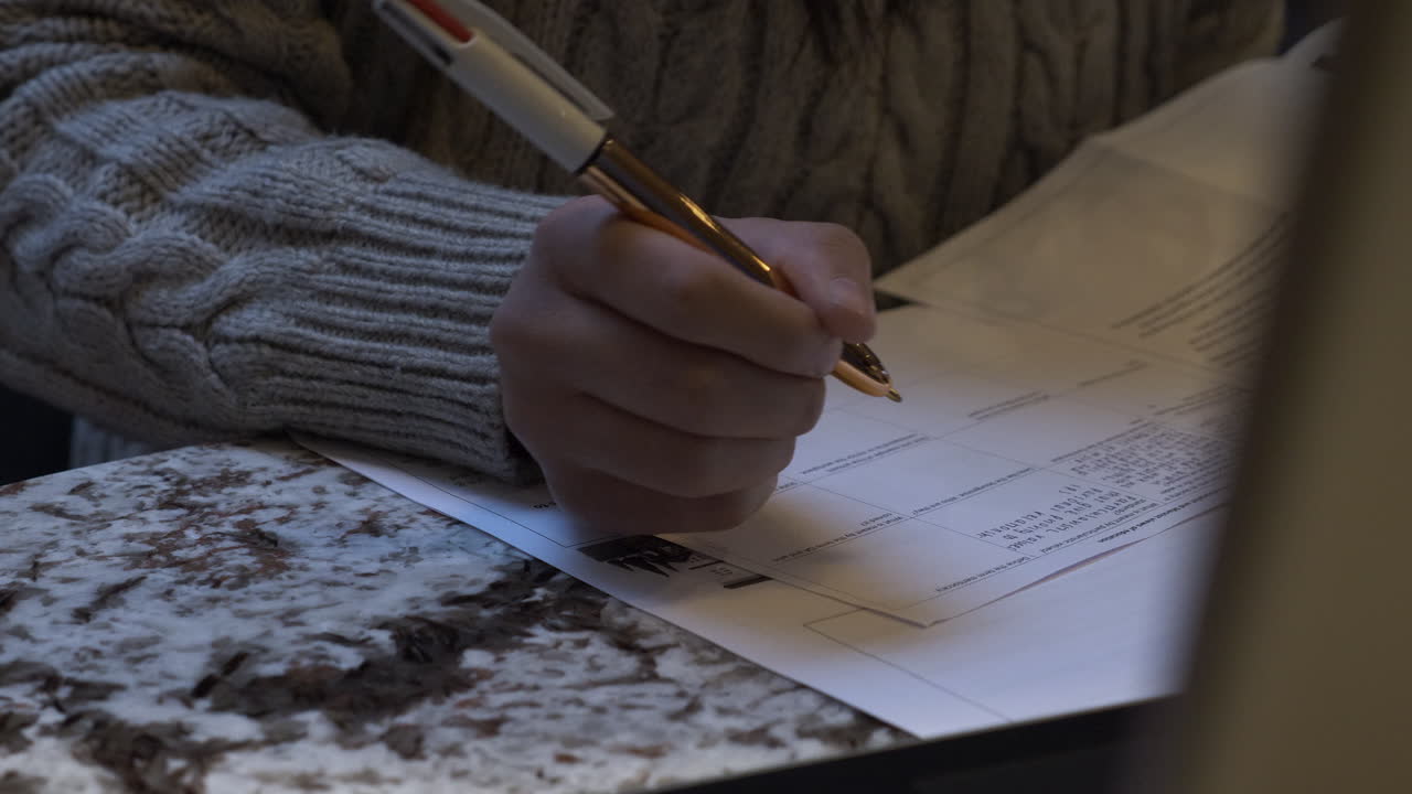 Right Hand Of Teenager Writing Doing Homework Indoors