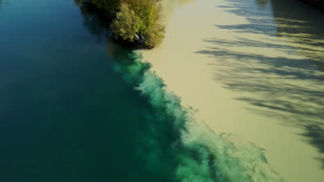two merging river of blue and brown collor in the town of geneva switzerland in 4k