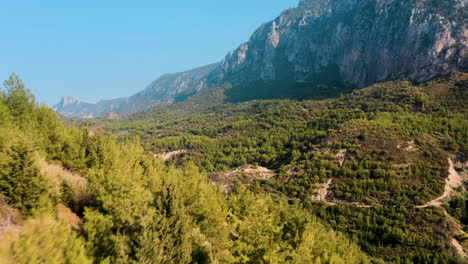 Low-areal-shot-over-sunlit-mountain-range