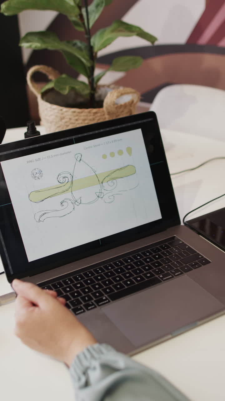 Vertical video of busy caucasian female worker using laptop in jewellery shop in slow motion