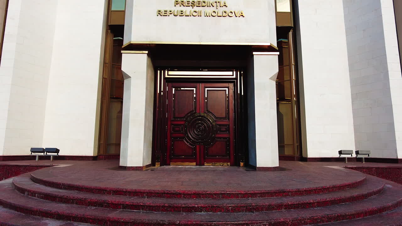 Chisinau, Moldova - December 23, 2021: Visitors admire the impressive design of the Presidential Palace in Moldova while taking in the beautiful surroundings on a bright afternoon