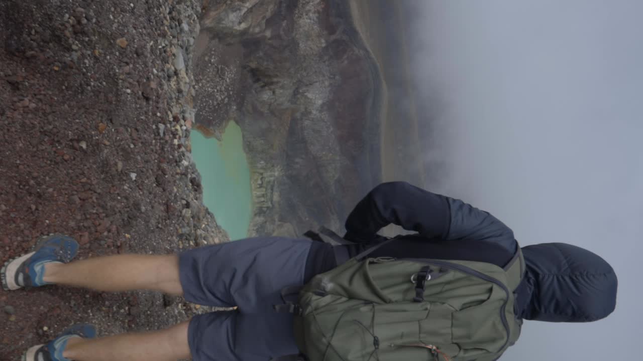 Tourist at Santa Ana Volcano El Salvador looking at crater lake vertical video
