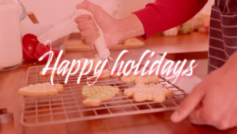 Animation-of-happy-holidays-text-over-caucasian-man-baking-in-kitchen