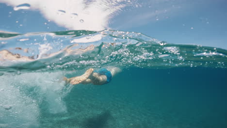 a man swimming at the ocean