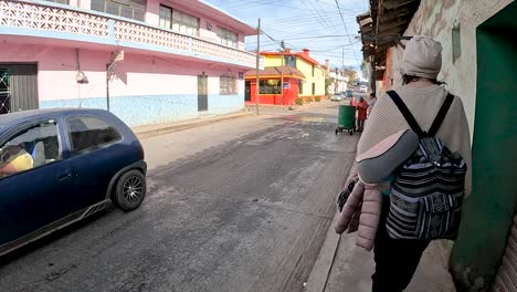 walking alongside a young woman through the streets of zacatlán de las manzanas, mexico