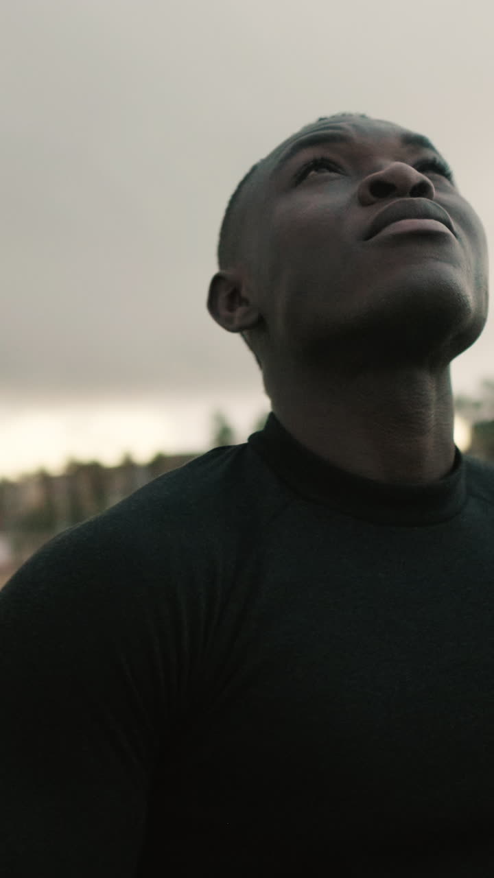 Young Black Man Looking Up with Contemplative Expression