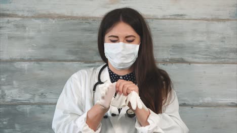 doctor putting on gloves and mask