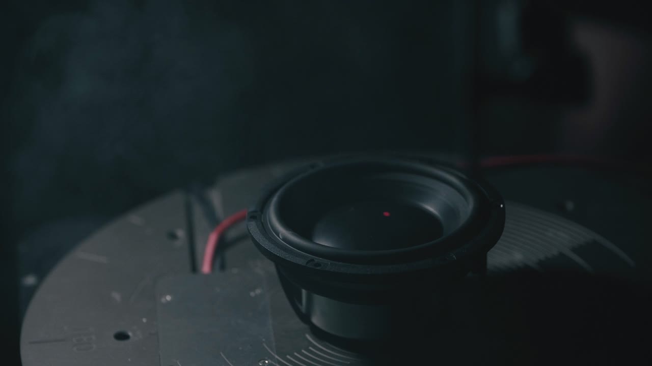 High-tech testing of a speaker using precision laser measurement, visible laser beams through smoke, acoustic vibration analysis, modern audio engineering