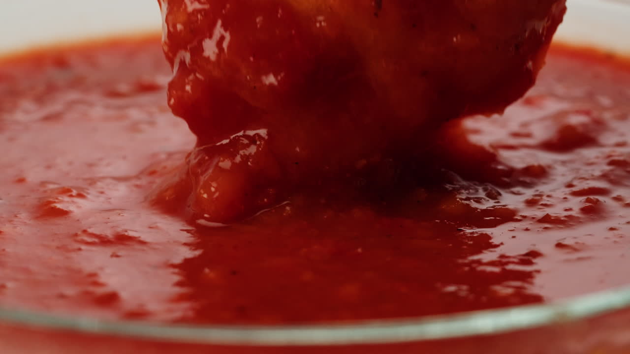 Finger food dipping in tomato sauce