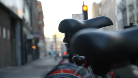 close up of bicycle saddles in urban setting