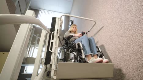 a girl in a wheelchair effortlessly ascends the stairs using a stair lift.