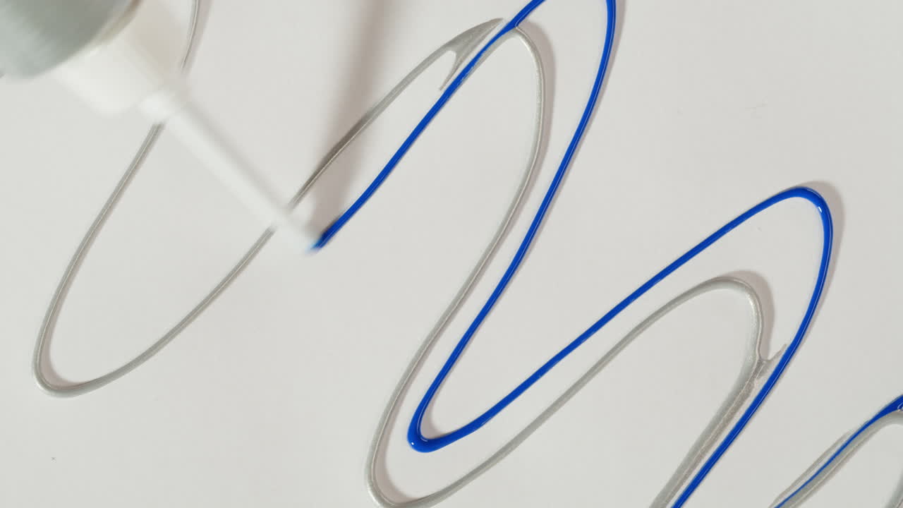 Hand Applying Blue Gel Over Silver Wavy Line