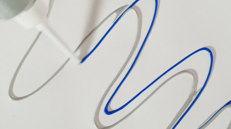 Hand Applying Blue Gel Over Silver Wavy Line