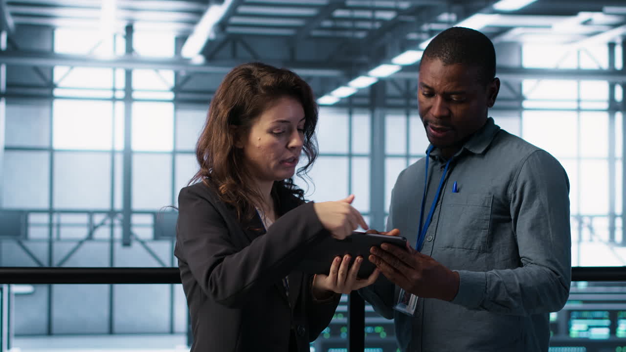 Data scientists in data center using tablet to develop disaster recovery plans