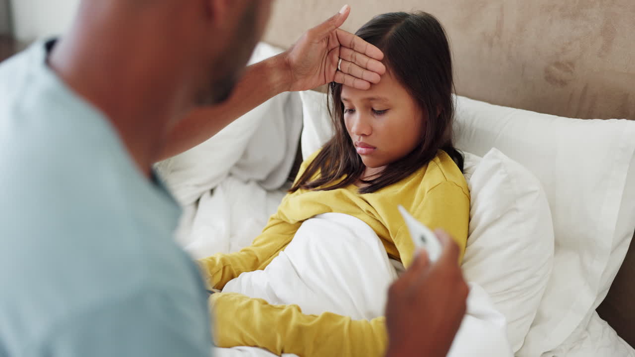 Fever, thermometer and a father with sick child