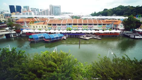 boat quay, singapore: colorful buildings and boats along the river