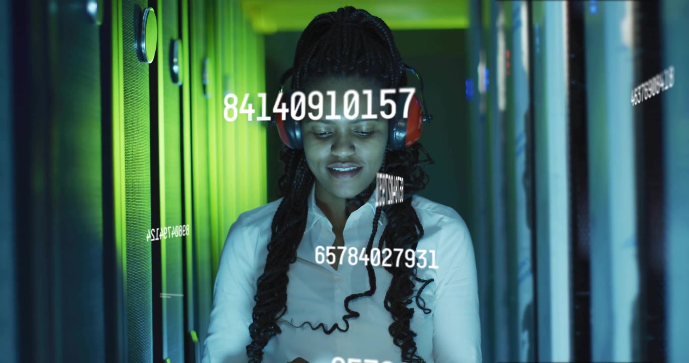 Woman monitoring datacenter servers, tapping console while watching numeric overlays passing over