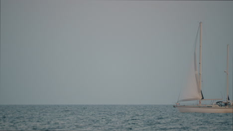 White-yacht-sailing-in-blue-sea-against-the-sky