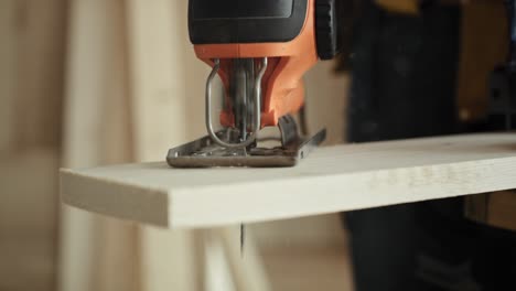 handheld video of sawing wood with an electric jigsaw