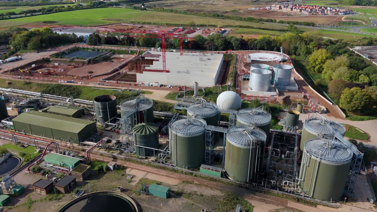 Drone footage of sewage processing infrastructure near Leicester, UK, with silos, tanks, and water treatment ponds