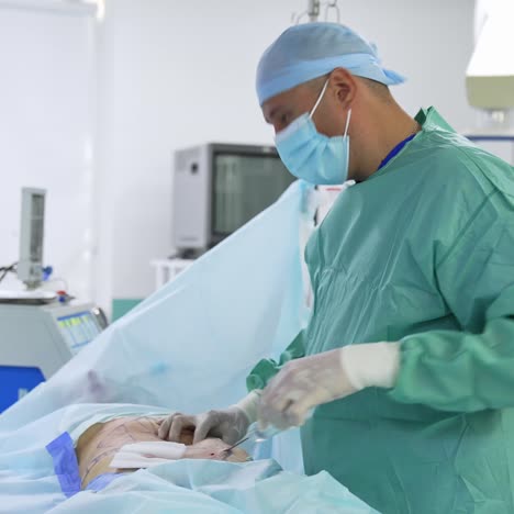 professional doctor performs an operation of liposuction. surgeon gathers the fat in abdomen. cosmetic surgery. improvement of patient's body