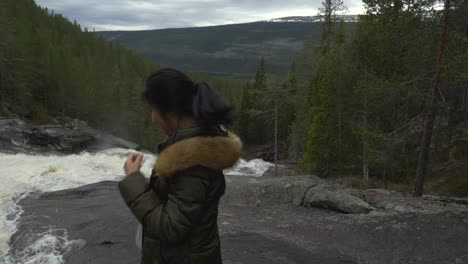 girl is having a goodtime by a waterfall