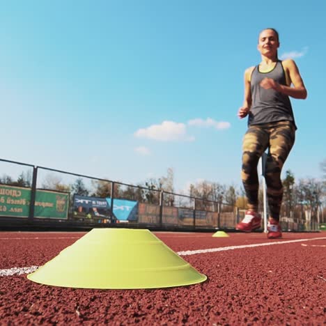 summer outdoors training. athletic woman running on track. beautiful body.