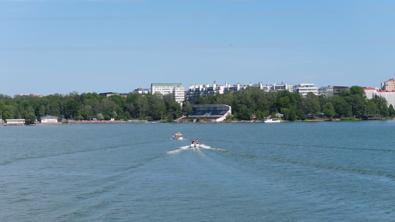 Aerial view circling motorboats on the coatline of Hietalahti, summer in Helsinki