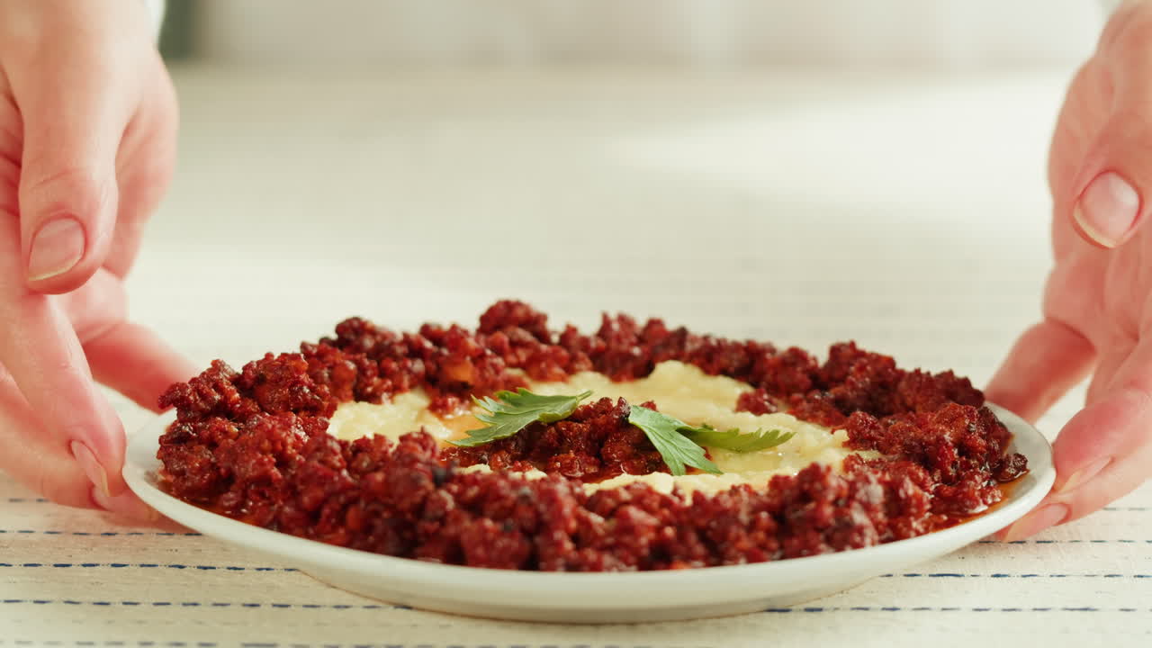 Serving a Plate of Middle Eastern Meat Dish