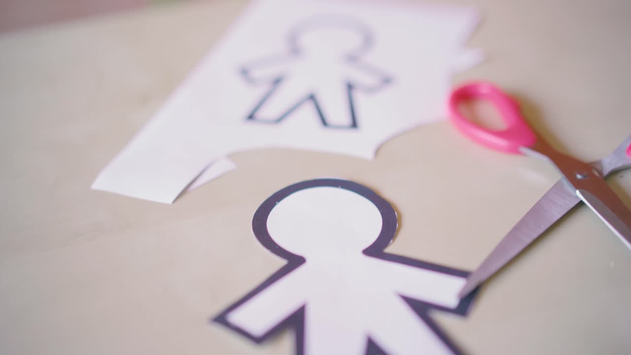 scissors cutting different paper silhouettes for April fools day