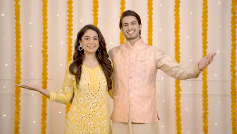 indian couple wishing happy diwali to the guests