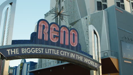 a vibrant shot captures the iconic reno arch during the daytime, showcasing its bold colors and welcoming message against a clear blue sky, embodying the spirit of the city.