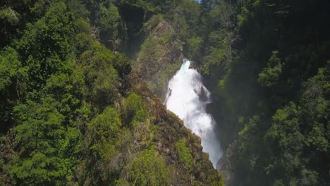 drone image panning over a waterfall where you can see from the base to where the waterfall is born