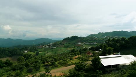 4K-Cinematic-nature-aerial-footage-of-a-drone-flying-over-the-beautiful-mountains-of-Mon-Jam-next-to-Chiang-Mai,-Thailand-on-a-sunny-day