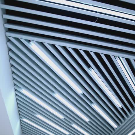 white ceiling with lighting in room. ceiling lights custom designed for an office business building