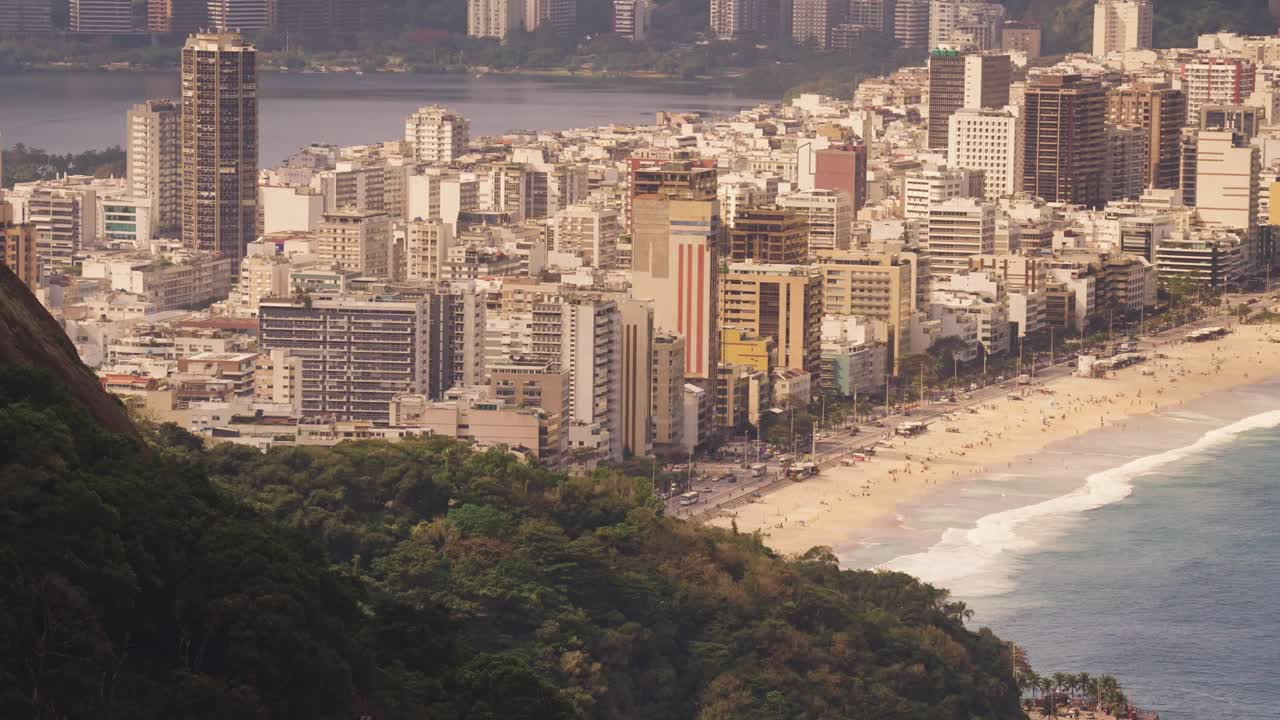 Aerial top down shot showing Copacabana District with skyscraper buildings in Rio de Janeiro at sunset