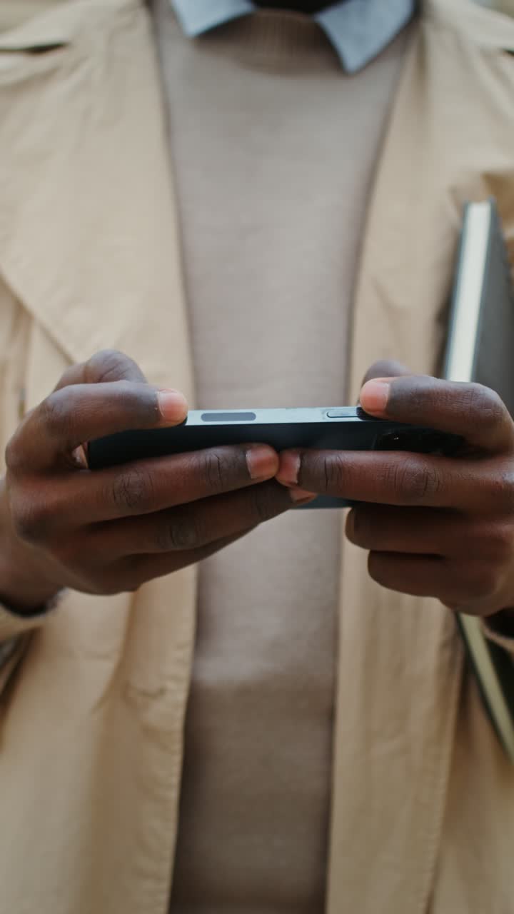 Person holding a smartphone and notebook