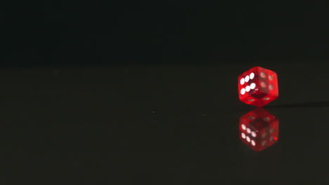 red dice spinning on black background