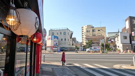 people walking across a city street intersection