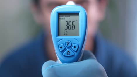 taking body temperature with digital thermometer