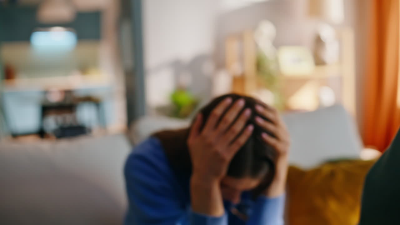 Unhappy mother holding templates suffering from active son sitting couch closeup