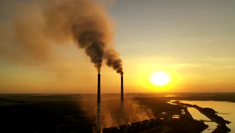 steam on chimney of power plant. air pollution from power plant chimneys