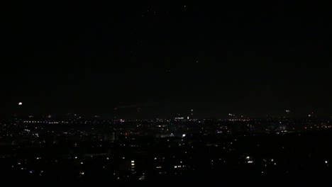 fireworks exploding over night city skyline during new year's eve celebrations