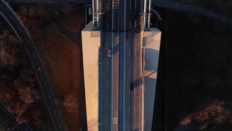 aerial view above traffic on the verrazzano-narrows bridge, fall sunset in ny, usa - top down, drone shot